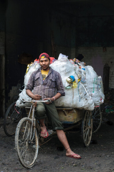 A rickshaw is loaded with recycle material in India.