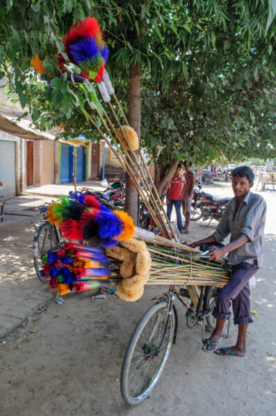 A bicycle is loaded up with brooms for sale in India.