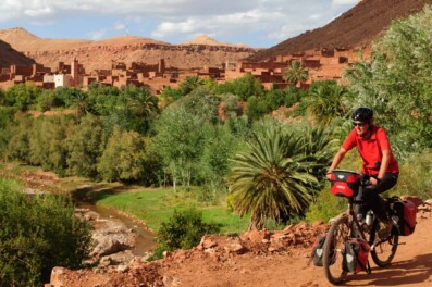 Cycling past a desert oasis in Southern Morocco
