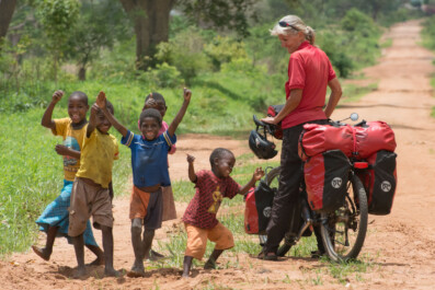 A touring bicyclist views local kids in Malawi, Africa.