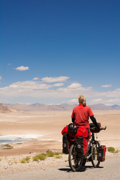 Touring cyclist looks out over the desert in Tajikistan.