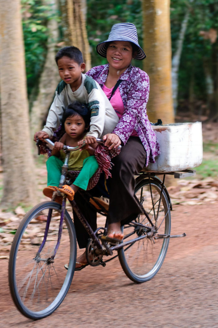 A family rides a single bicycle in Cambodia