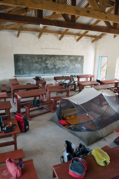 Touring cyclists camp in a School classroom in Africa.