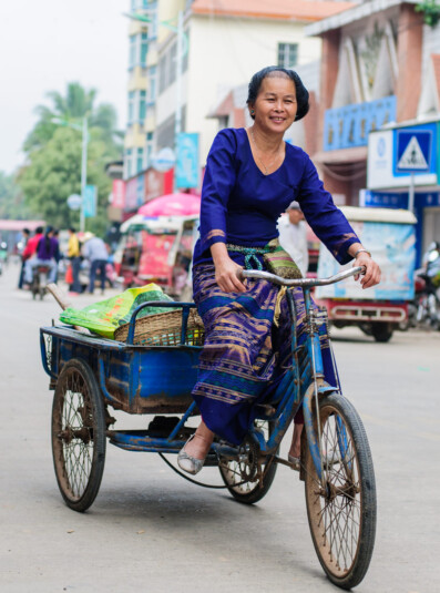 A Chinese lady cycles to the market on her cargo bike