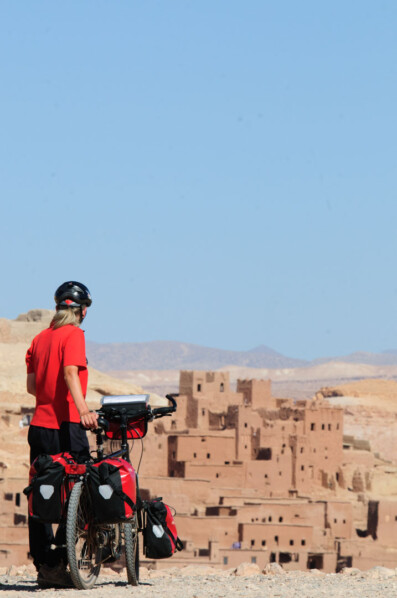 A touring cyclist looks out over Ait Ben Hadou in Morocco
