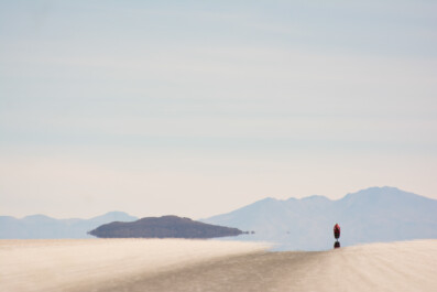 A little red bicyclist heads across the Salar de Uyuni in Bolivia