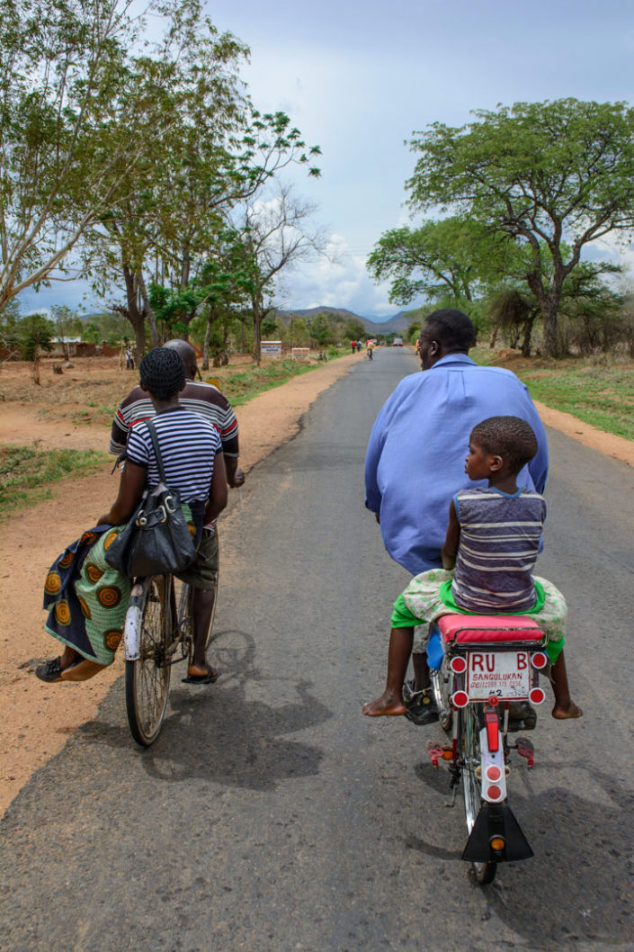 Bicycle culture - bike taxis pedal down a highway in Africa.