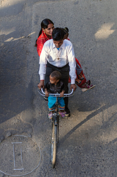 A family rides a bicycle in India.