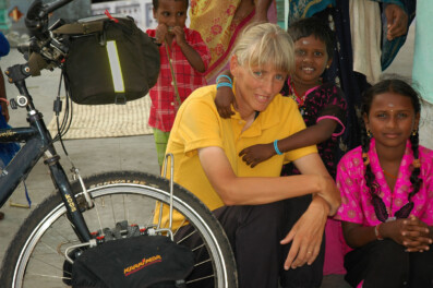 A Western cyclist meets local kids in India.