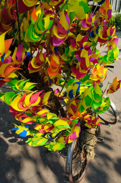 Pinwheels are piled on top of a bicycle in Vientiane, Laos