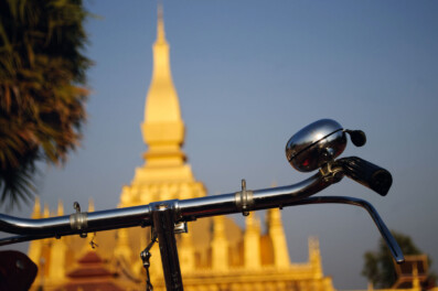 A bicycle stands in front of the temple in Vientiane, Laos