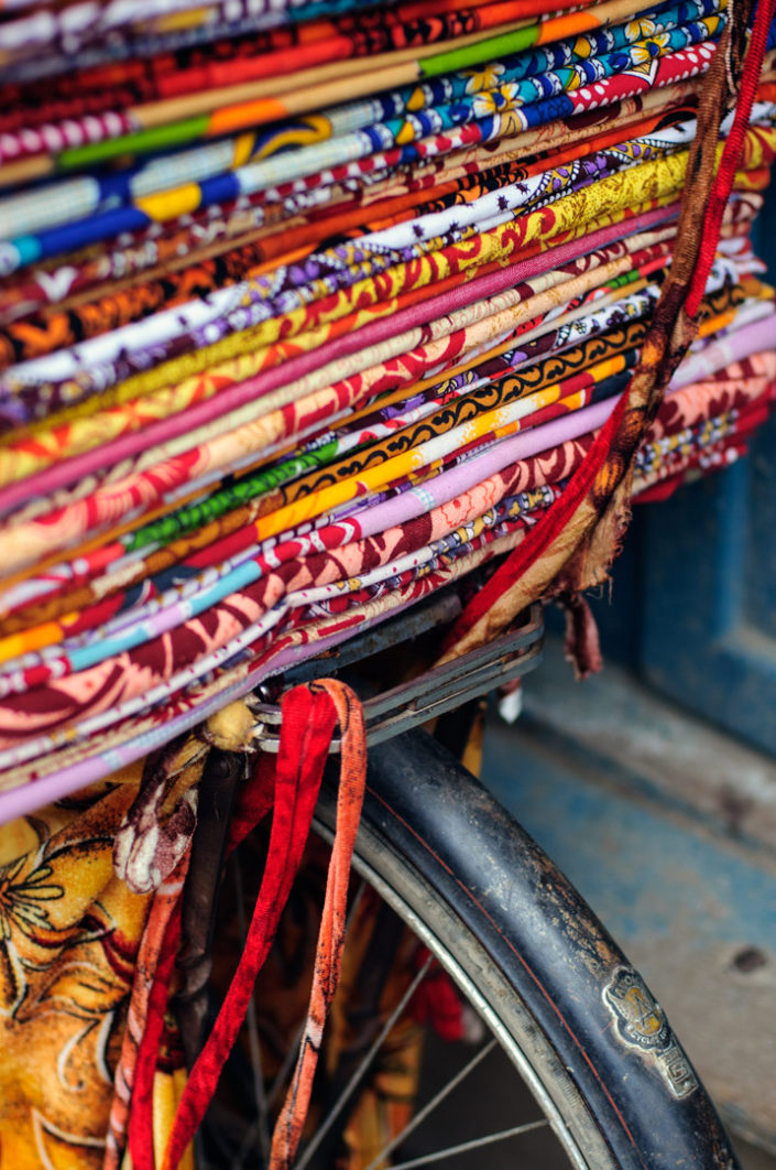 Cloth is piled on top of a bicycle rack in Kathmandu, Nepal.
