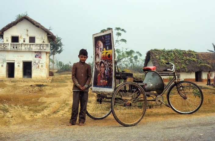 a rickshaw advertises a bollywood film in Nepal.