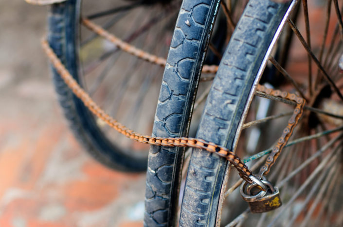 Bicycle wheels are locked together via a bicycle chain in Kathmandu.
