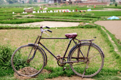 An old Nepal bicycle stands near a field in Nepal