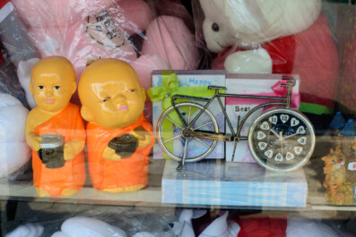 A bicycle clock is for sale in a Thai store window