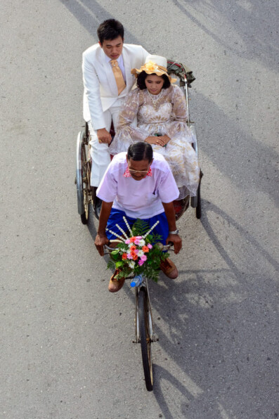 Rickshaws ferry passengers in fancy dress during a parade in Thailand