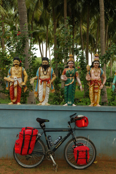 A fully loaded touring bicycle is leaned against a temple wall in South India.