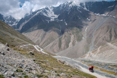 A cyclist takes a pause while heading up the Kunzum La pass in North India.