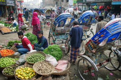 Main street Mymensingh Bangladesh with rickshaws and a market