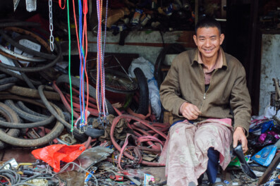 A Chinese man sits in his bicycle repair shop