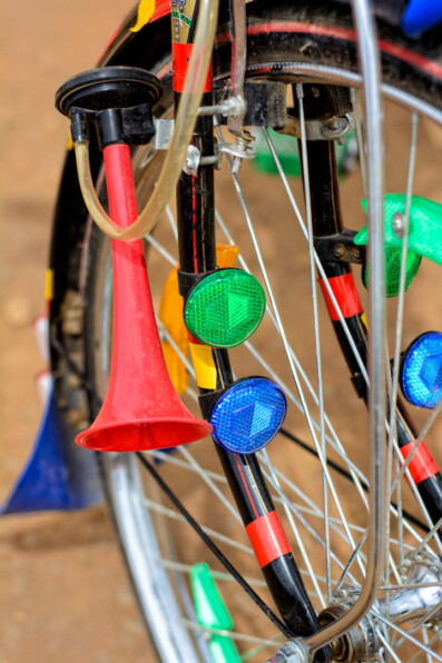 A bicycle front wheel full of reflectors plus a horn in Africa
