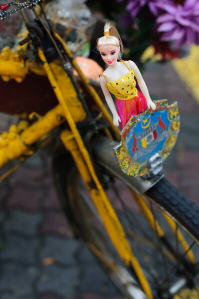 A tourist rickshaw is decorated with barbie dolls in Malacca, Malaysia