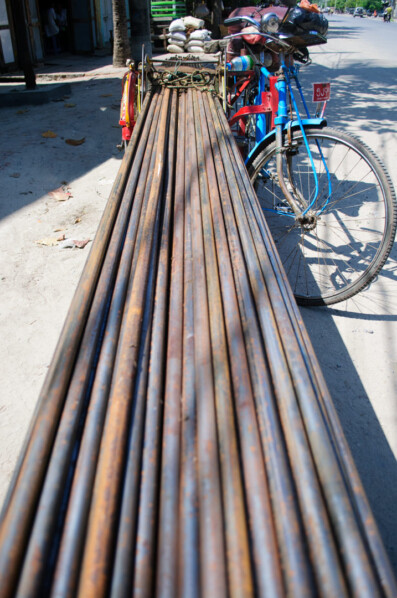 A trishaw is loaded with steel rebar in Myanmar