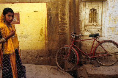 A red bicycle leans against a wall in Jaisalmer, India
