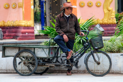 A Chinese cargo bike chauffeur waits for customers