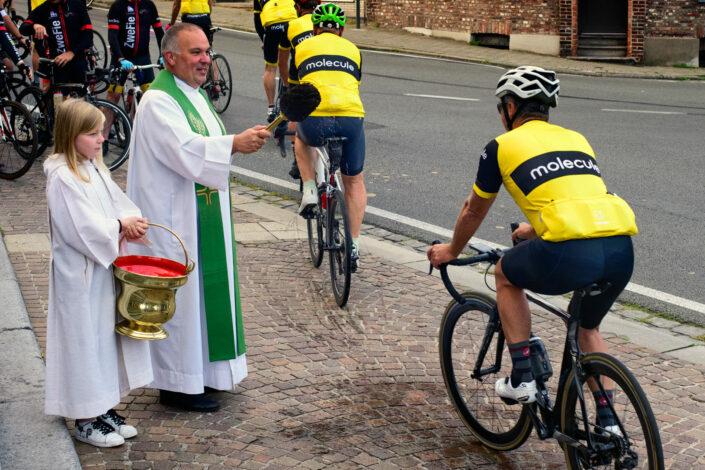Priest Dirk Decuypere blesses cyclists in Zwevegem Belgium.