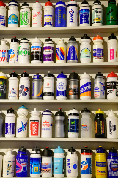 Bicycle water bottles from pro racing teams are on display in the Centrum Ronde van Vlaanderen Oudenaarde, Belgium.
