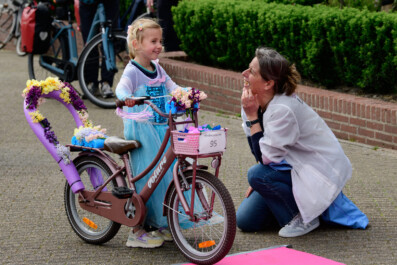 Bicycle culture in the Netherlands - a woman and young girl at the Kindercorso in Lisse.