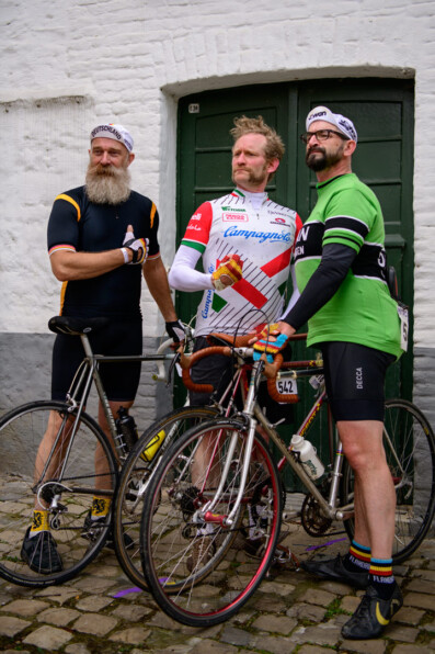 Belgian bicycle culture - three riders wearing wool jerseys pose next to their steel bikes at the Retro Ronde in Oudenaarde.